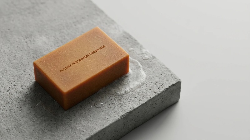 Persimmon tannin soap bar on concrete slab Persimmon tannin soap bar on concrete slab